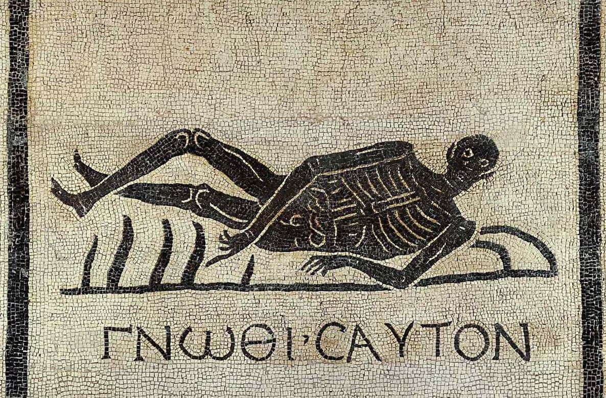 Roman mosaic of a reclining skeleton beneath the Greek inscription know thyself